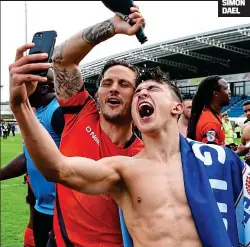  ?? PICTURES: SIMON DAEL ?? Get the party started: Wycombe’s Sam Saunders (left) and Luke O’Nien celebrate their promotion to League One