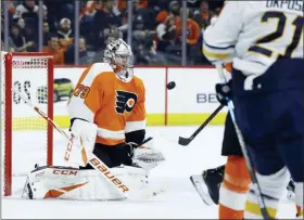  ?? MATT SLOCUM – ASSOCIATED PRESS ?? Flyers goalie Carter Hart, left, blocks a shot during the first period on Saturday at the Wells Fargo Center. He blocked 38 in all in a 3-1 win.