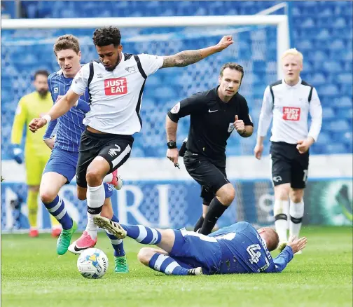  ??  ?? BALANCING ACT: Derby defender Cyrus Christie avoids the sliding challenge of Sheffield Wednesday midfielder Barry Bannan