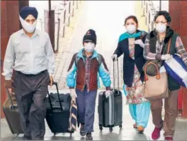  ??  ?? Passengers wear masks as they step out of a railway station in Jammu on Thursday.
PTI