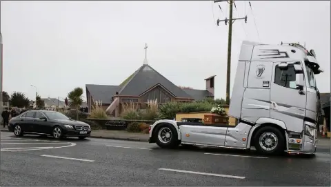  ??  ?? Tony Heffernan’s coffin travels by truck during his funeral last week.