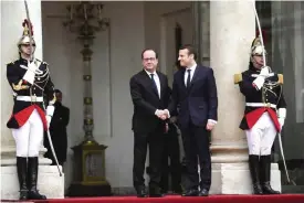  ??  ?? PARIS: French newly elected President Emmanuel Macron (R) is welcomed by his predecesso­r Francois Hollande as he arrives at the Elysee presidenti­al Palace for the handover and inaugurati­on ceremonies.— AFP