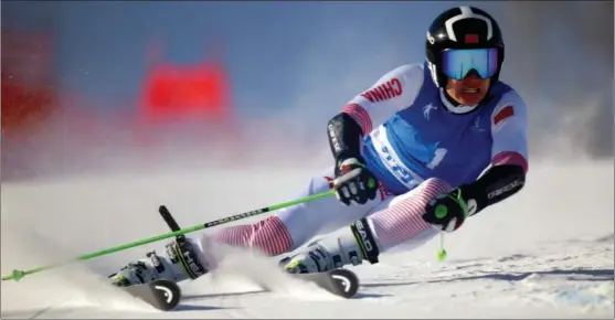  ?? XINHUA ?? Murat Akcholi, from Jilin province, skis to victory in the men’s giant slalom at the Chinese National Winter Games in Chifeng, Inner Mongolia, on Dec 28. His winning time was 2 min 4.70 sec.