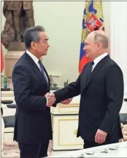  ?? Anton Novoderezh­kin/SPUTNIK/AFP via Getty Images/TNS ?? Russian President Vladimir Putin meets with China’s Director of the Office of the Central Foreign Affairs Commission Wang Yi at the Kremlin in Moscow on Feb.22.