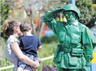  ??  ?? A member of the Green Army Patrol meets visitors at Toy Story Land at Walt Disney World near Orlando, Florida.