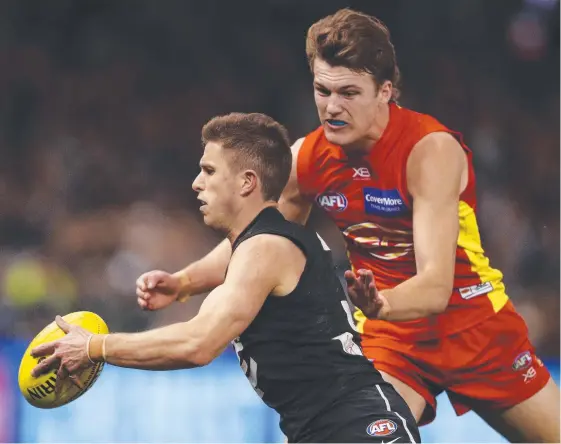  ?? Picture: AAP IMAGE ?? Suns young gun Jack Lukosius tackles Carlton’s Marc Murphy in a match last month. Lukosius has delayed contract talks until after the season.