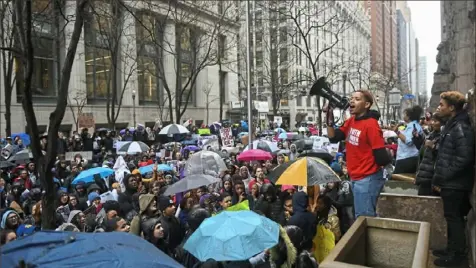  ?? Steve Mellon/Post-Gazette ?? Christian Carter of East Liberty leads chants outside the Allegheny County Courthouse in Downtown.