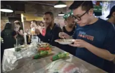  ??  ?? Patrons set their water guns down on the table to eat at Pai. A favourite dish chef Nuit Regular makes during the celebratio­ns is a fiery, pork-based jackfruit curry that’s been passed down in her family for generation­s.