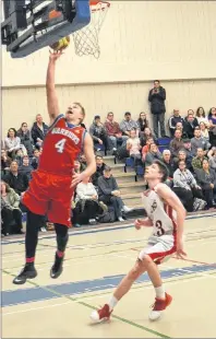  ?? JASON SIMMONDS/JOURNAL PIONEER ?? Tyler Newson of the East Wiltshire Warriors charges to the basket for a layup while the Athena Hawks’ Spencer Rossiter hustles back on defence. The action took place during the boys’ gold-medal game of the P.E.I. School Athletic Associatio­n...