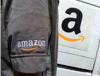  ?? Reuters ?? An Amazon.com Inc driver stands next to an Amazon delivery truck in Los Angeles, California. —