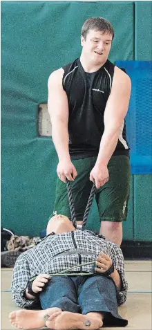  ?? JESSICA NYZNIK/EXAMINER STAFF ?? Fleming College student Scott Clyne, studying pre-service firefighti­ng, competes in a challenge during the First Responders Cup at the Peterborou­gh Sports and Wellness Centre Saturday.