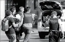  ?? ASSOCIATED PRESS ?? AN INJURED PERSON IS CARRIED IN BARCELONA, SPAIN, on Thursday after a white van jumped the sidewalk in the historic Las Ramblas district, crashing into a summer crowd of residents and tourists, police said.