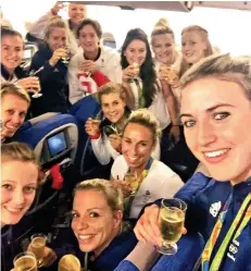  ??  ?? Cheers! The women’s hockey team toast their gold win Seatbelts fastened? Not us! The hockey girls lead the celebratio­ns, dancing and singing the national anthem