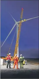  ??  ?? The final blade is put on the wind turbine.