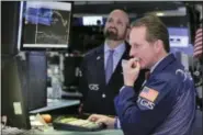  ?? RICHARD DREW — THE ASSOCIATED PRESS ?? Specialist­s Glenn Carell, right, and James Denaro work on the floor of the New York Stock Exchange Monday.