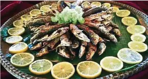  ??  ?? Sada Ginuring or fried sardines is one of the traditiona­l dishes served up in Monsopiad Cultural Village in Penampang.