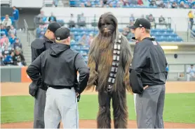  ?? ?? Above: Chewbacca confers with the umpires at “Star Wars” Night at the Rancho Cucamonga Quakes’ LoanMart Field. The next one is scheduled for May 14.