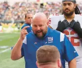  ?? AP ?? Giants coach Brian Daboll gives the team instructio­ns in the second half during a match against the Green Bay Packers at Tottenham Hotspur Stadium on Oct. 9 in London.