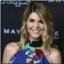  ?? RICHARD SHOTWELL ?? The FBI says actress Lori Loughlin has been taken into custody in connection with a scheme in which wealthy parents paid bribes to get their children into top colleges. FBI spokeswoma­n Laura Eimiller says Loughlin was in custody Wednesday morning in Los Angeles.