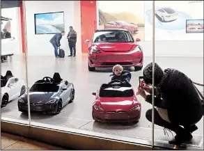  ?? AP ?? A child climbs into a battery operated ride-on Tesla car, at a showroom in Chicago last weekend. U.S. retail sales rose in October by 0.8 percent, the Commerce Department said Thursday.