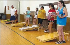  ?? Special to the Eagle Observer/DANIEL BEREZNICKI ?? Players get into position, ready to start the cornhole tournament.