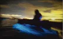  ?? PATRICK CONNOLLY/ORLANDO SENTINEL/TNS 2018 ?? A long-exposure photo shows the biolumines­cent blue glow of dinoflagel­lates beneath kayaks outside of Titusville, Florida.