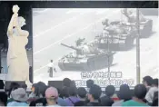  ??  ?? People watch footage from 1989, of a lone man confrontin­g tanks, as they attend a Tiananmen 30th anniversar­y gathering in Taipei, Taiwan, yesterday