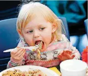  ?? [PHOTOS BY NATE BILLINGS, THE OKLAHOMAN] ?? Aurora Coleman, 2, eats lunch Thursday at the Salvation Army Chesapeake Energy Center of Hope.