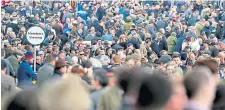  ??  ?? Racegoers at the Cheltenham Festival on Friday