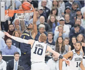  ?? SOOBUM IM/USA TODAY SPORTS ?? Michigan guard Charles Matthews dunks over Villanova guard Donte DiVincenzo during the NCAA tournament championsh­ip game.