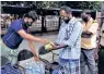  ??  ?? Food parcels being offered to needy people at Mattuthava­ni