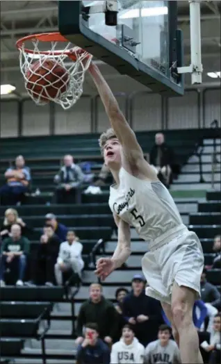  ?? PAUL DICICCO — FOR THE NEWS-HERALD ?? Lake Catholic’s Luke Frazier dunks against Cornerston­e Christian on Feb. 5. Frazier scored his 1,000th career point in the game.