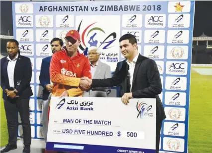  ??  ?? STAR OF THE SHOW . . . Zimbabwe batsman Brendan Taylor receives his man-of-the-match cheque for his brilliant century in leading the Chevrons to victory over Afghanista­n in Sharjah on Sunday