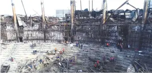  ?? (Russian Emergencie­s Ministry/Reuters) ?? WORKERS REMOVE debris inside the burnt-out Crocus City Hall following last week’s deadly attack on the concert venue near Moscow.