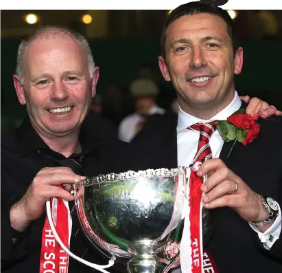  ??  ?? Better days: McInnes (right) and former Aberdeen chairman Stewart Milne with the League Cup