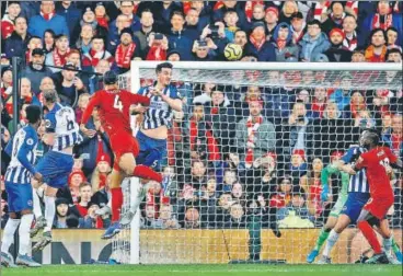  ?? REUTERS PHOTO ?? Liverpool's Virgil van Dijk heads home the second goal against Brighton on Saturday..