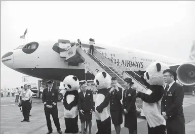  ??  ?? This file photograph shows a British Airways plane emblazoned with panda-like black-and-white features, after it landed at the Chengdu Shuangliu Internatio­nal Airport. Its crew received a warm welcome from local staff dressed as panda mascots.