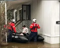  ?? COURTESY PHOTOGRAPH ?? A woman and a child were evacuated from a flooded mobile home park last week in Acampo.