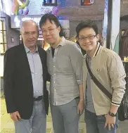  ??  ?? Above: Yu interviews a foreign visa applicant. Right: Yu (center) and his friend (right) bump into Sven-Goran Eriksson, former head coach of Shanghai SIPG football club in Xintiandi. — Ti Gong