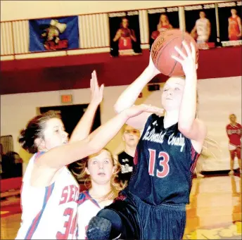  ?? RICK PECK/SPECIAL TO MCDONALD COUNTY PRESS ?? McDonald County’s Meagan Mills gets fouled while taking a shot by Seneca’s Chelsea Beville during the Lady Mustangs’ 46-36 win on Feb. 3 in the third-place game of the Seventh Annual Seneca Ladies Basketball Tournament.