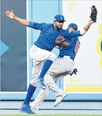  ?? Wally Skalij Los Angeles Times ?? CUBS CENTER FIELDER Dexter Fowler collides with right fielder Jorge Soler but still catches a fly ball off the bat of Dodgers’ Josh Reddick in the second inning. Neither outfielder was injured.