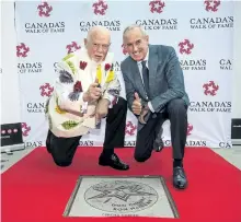  ?? AARON VINCENT ELKAIM/THE CANADIAN PRESS ?? Don Cherry and Ron MacLean pose for a photo during the unveiling of their joint star on Canada's Walk of Fame in Toronto on Monday.
