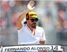  ??  ?? Fernando Alonso waves to the crowd on the drivers parade before the Canadian Formula One Grand Prix at Circuit Gilles Villeneuve in Montreal, Canada in this June 10 file photo. — AFP photo