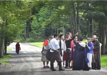  ??  ?? A group of costumed role players make a plan for warding off an attack by another group at Epic Nerd Camp.