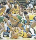  ?? AP PhoTo ?? Earvin (Magic) Johnson of the Los Angeles Lakers scrambles for the ball on the floor of The Forum during the 1987 NBA Finals.