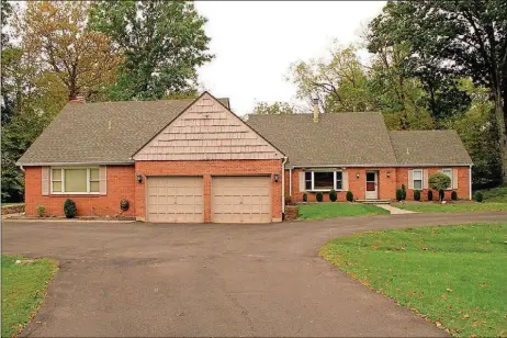  ?? CONTRIBUTE­D PHOTOS BY KATHY TYLER ?? The brick-and-cedar home has about 5,540 square feet of living space on the three levels. The house sits on 5.4 acres with three-lined creek.