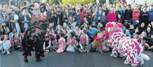  ?? PHOTO: PETER MCINTOSH ?? Cultural connection . . . Excited youngsters reach out to lions at the start of a lion dance at the Dunedin Chinese Garden last night to welcome the start of the Chinese New Year.