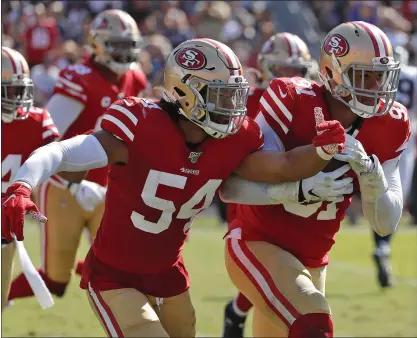  ?? JOHN LOCHER – THE ASSOCIATED PRESS ?? San Francisco 49ers defensive end Arik Armstead, right, made a another game-turning play by recovering a fumble early in the second half to set up a touchdown run by Jimmy Garoppolo. The 49ers defense crushed the Rams’ hopes with a relentless performanc­e.