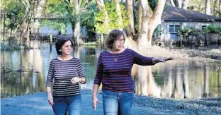  ?? PHOTOS BY JOE BURBANK/STAFF PHOTOGRAPH­ER ?? Karen Blaydes, right, and her neighbor, Lydia Levasseur, survey the damage at Blaydes’ Longwood home that was flooded when a retention pond built for the Ultimate I-4 project burst during Hurricane Irma.