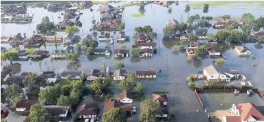  ?? AP ?? In this aerial photo taken on Friday, September 1, homes sit in floodwater­s caused by Tropical Storm Harvey in Port Arthur, Texas. Port Arthur’s major roads were swamped by rising waters brought by Harvey.